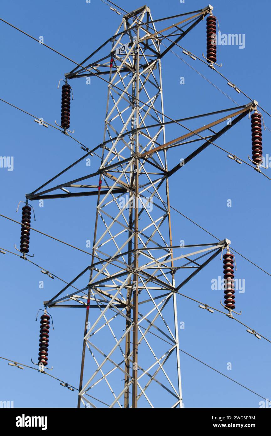 Electricity pylons, also known as electricity transmission and distribution towers, support high-voltage overhead power lines. Stock Photo
