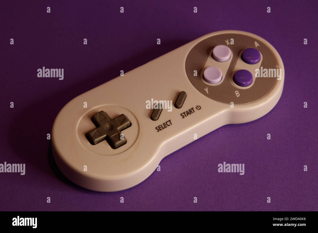 Nintendo type video game contollers on a mouve background, studio photography Stock Photo