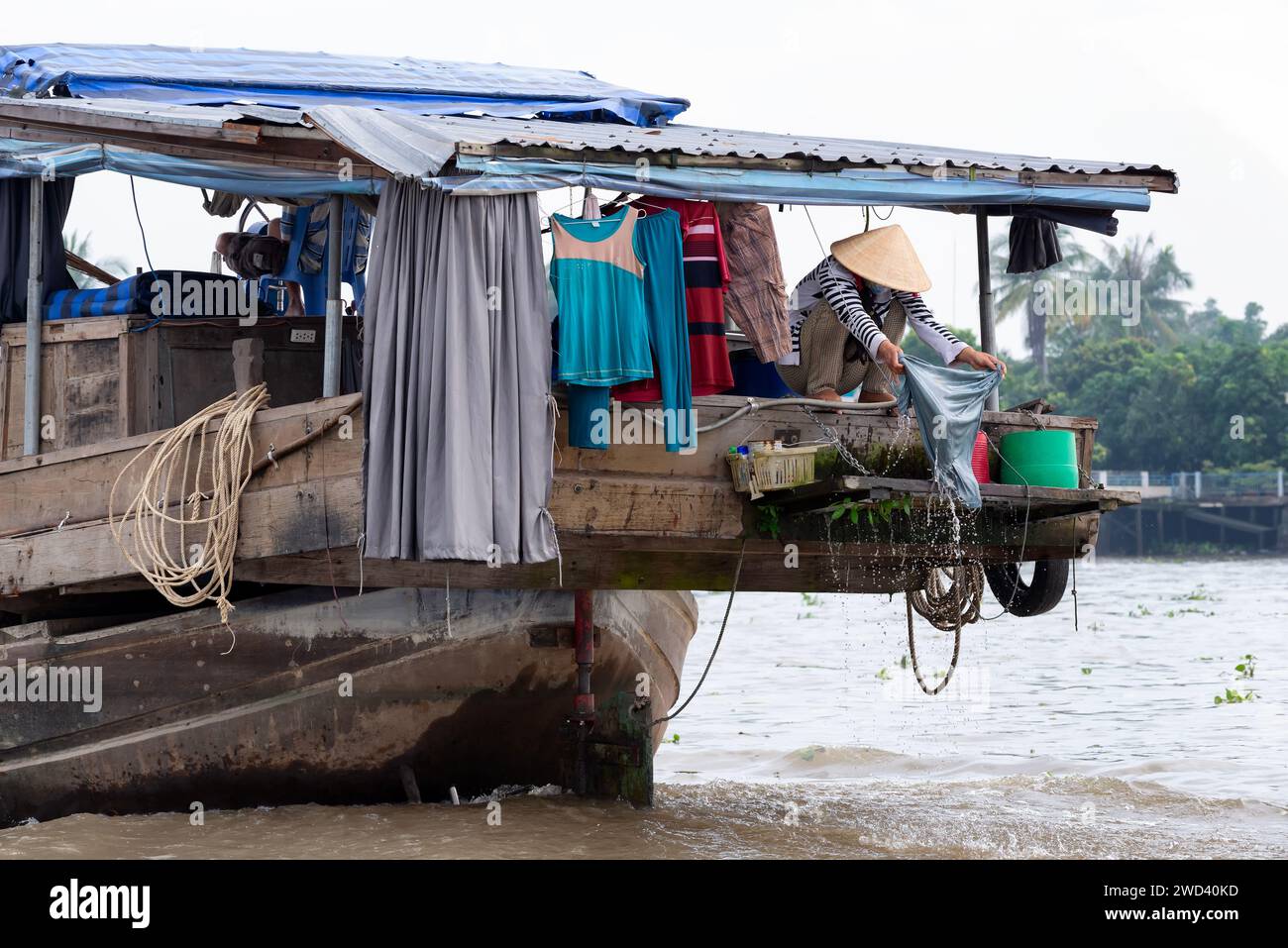 Vietnamese woman doing the laundry in the boat Stock Photo