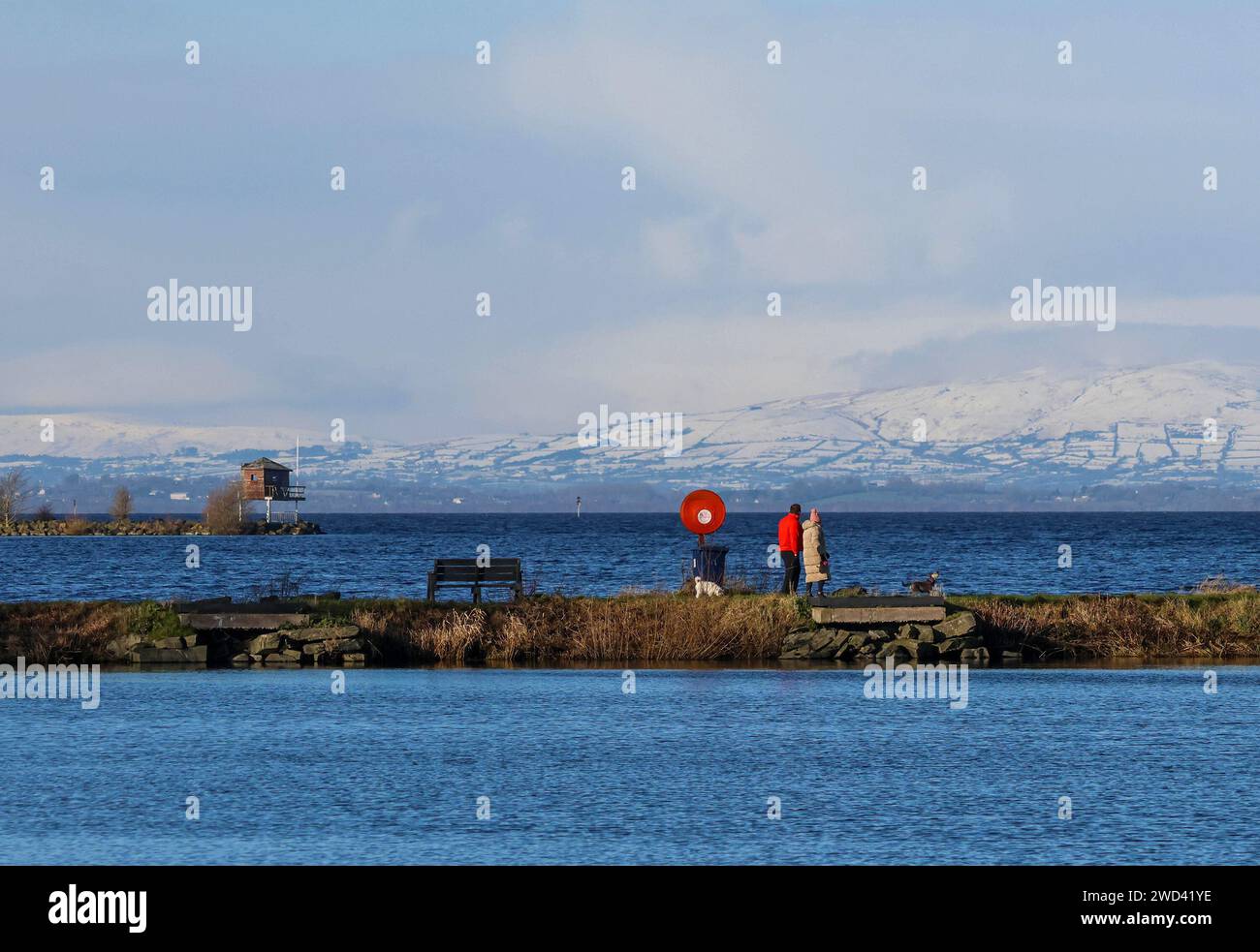 Kinnego, Lough Neagh, County Armagh, Northern Ireland, UK. 18th Jan 2024. UK weather – a bright day with sunshine but bitterly cold as the cold snap from Arctic air flow continues across Northern Ireland. Snow lying on the Sperrin Mountains on the northern shore of Lough Neagh. Credit: CAZIMB/Alamy Live News. Stock Photo