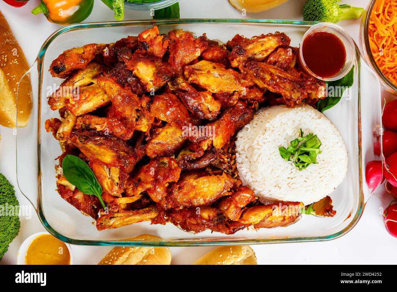 Served with rice these baked chicken wings are spicy. Stock Photo