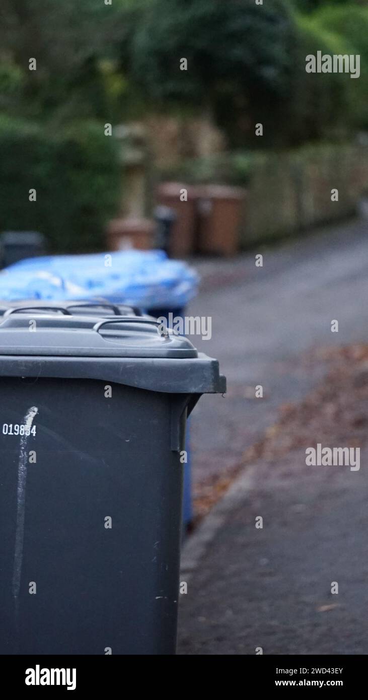 Set of bins lined up on the edge of a road Stock Photo - Alamy