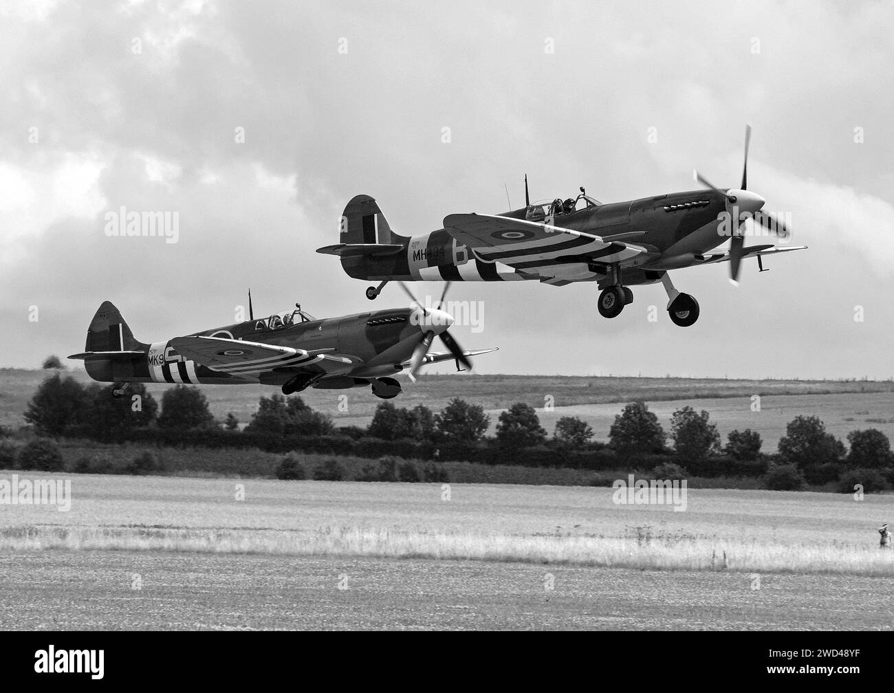 Spitfire fighter planes taking off in black and white at Duxford airshow. Stock Photo