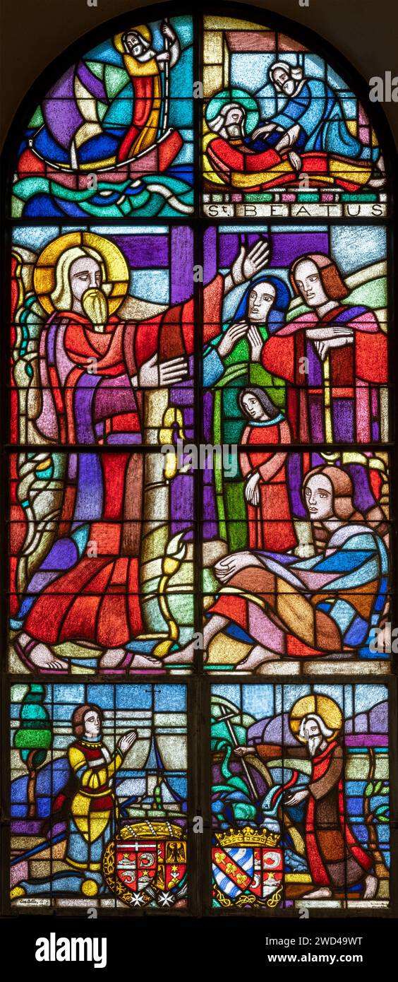 BERN, SWITZERLAND - JUNY 27, 2022: The St. Beatus on the stained glass in the church Dreifaltigkeitskirche by Jean-Edouard de Castella (1881–1966). Stock Photo