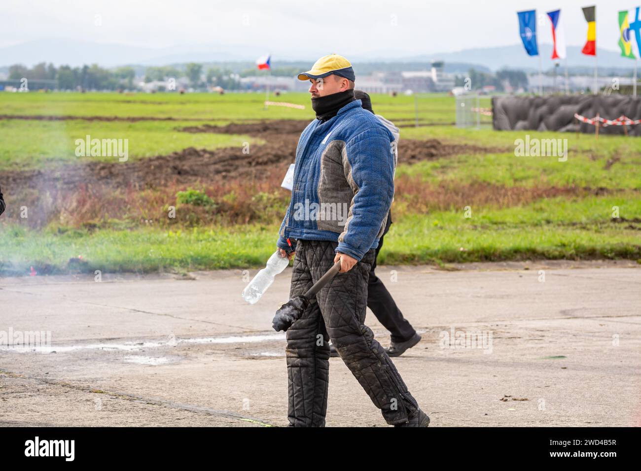 Rioters and protestors at civil unrest demonstration during NATO days airshow. Angry people with flags, bottles, objects and fire. Stock Photo