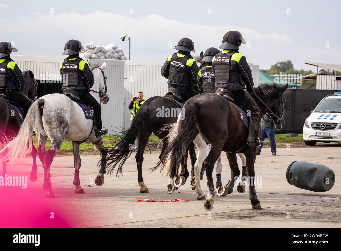 Riot police on horseback. Czech Republic city police officers mounted on horses riding their steeds into a crowd of protestors during a demonstration. Stock Photo