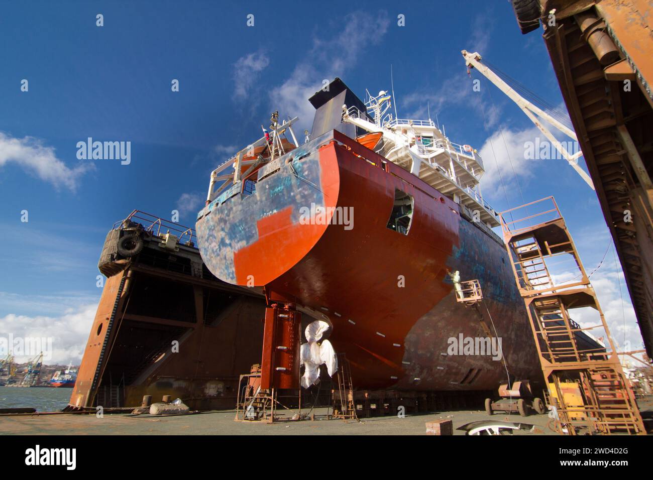 Commercial vessel in dry dock for maintenance. Ship undergoes hull