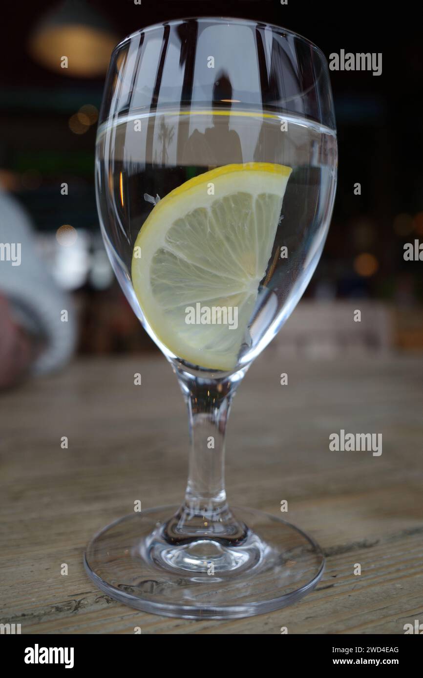 Glass of mineral water with a slice of lemon Stock Photo - Alamy