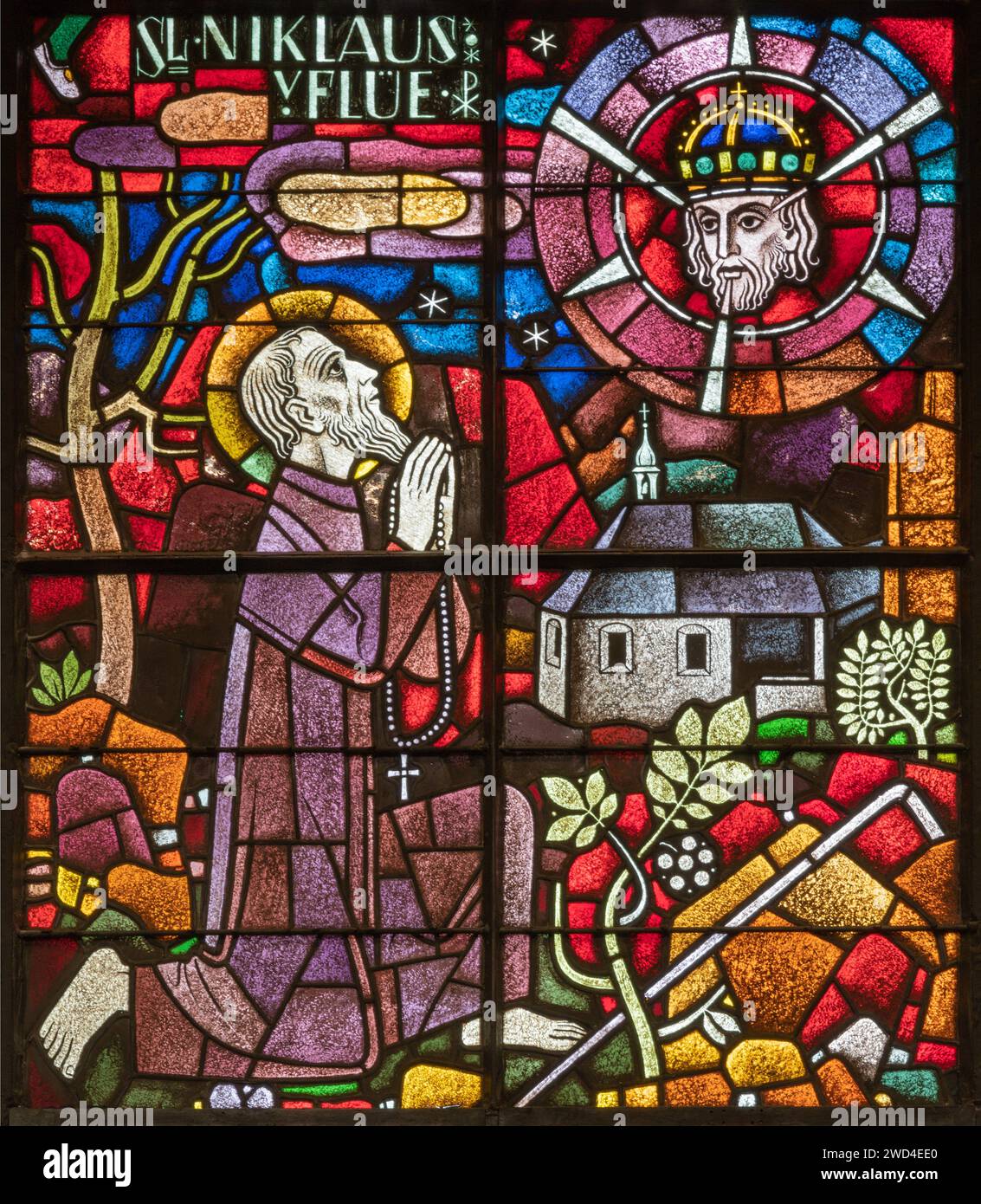 BERN, SWITZERLAND - JUNY 27, 2022: The St. Nicholas of Flue on the stained glass in the church Dreifaltigkeitskirche by A. Schweri (1938). Stock Photo