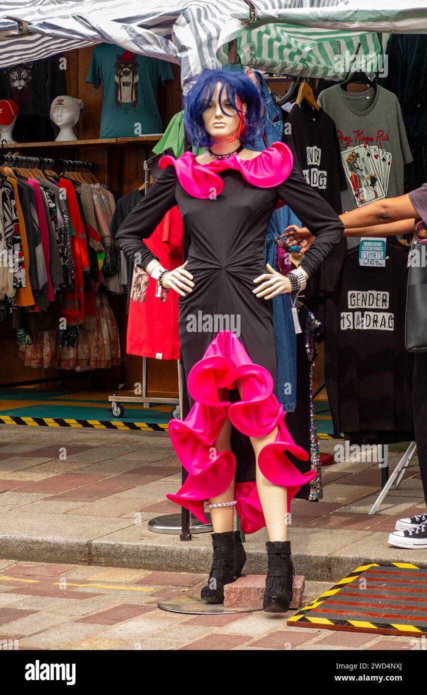 Female mannequin displays trendy eye catching outfit at outdoor market. Stock Photo