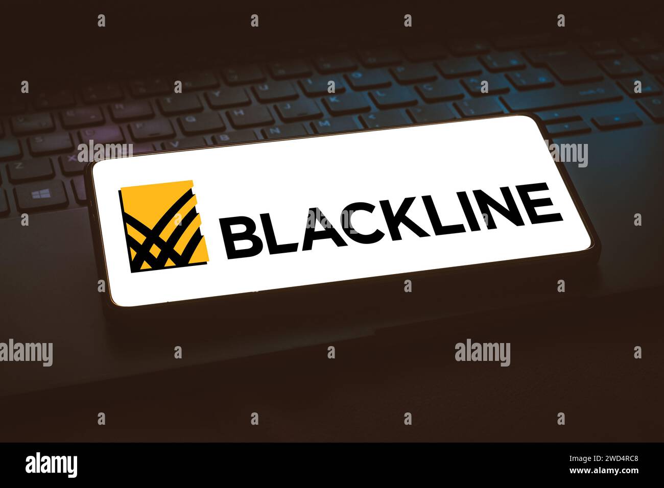 In this photo illustration, the BlackLine Systems, Inc. logo is displayed on a smartphone screen while resting on a laptops' keyboard. Stock Photo