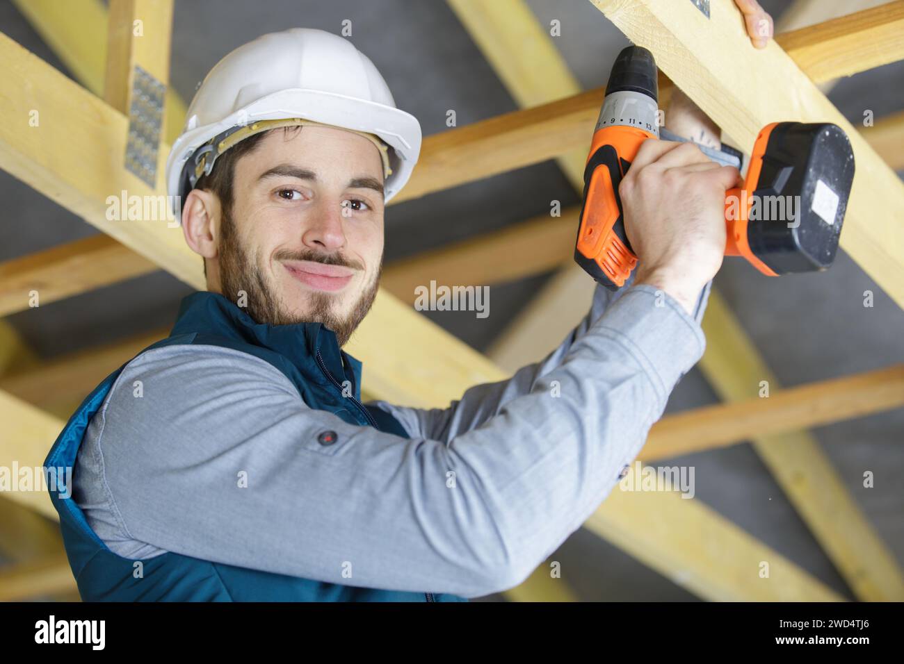 mature carpenter drilling wood Stock Photo