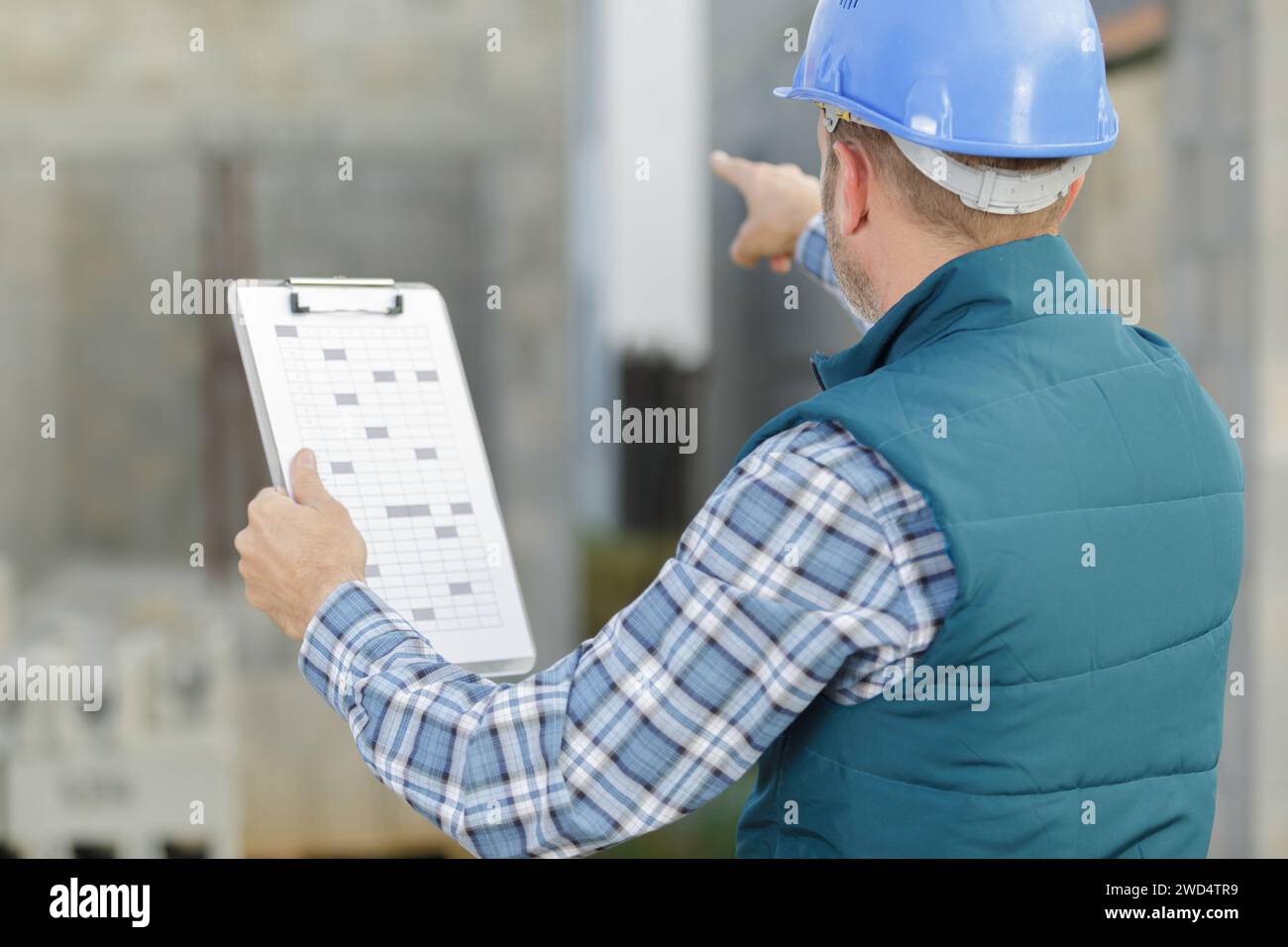 warehouse worker pointing with finger while standing Stock Photo