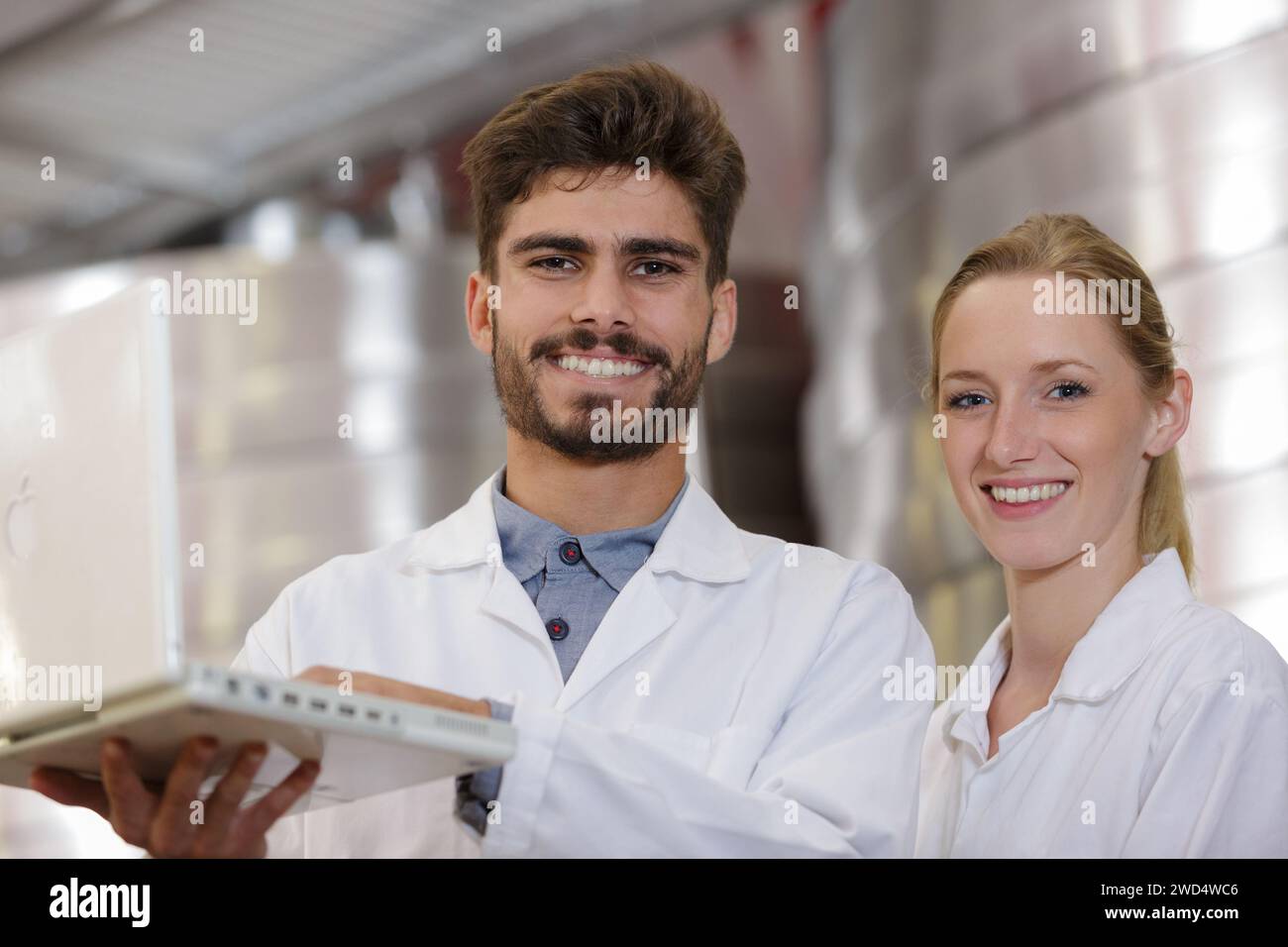 couple of young workers using a laptop Stock Photo