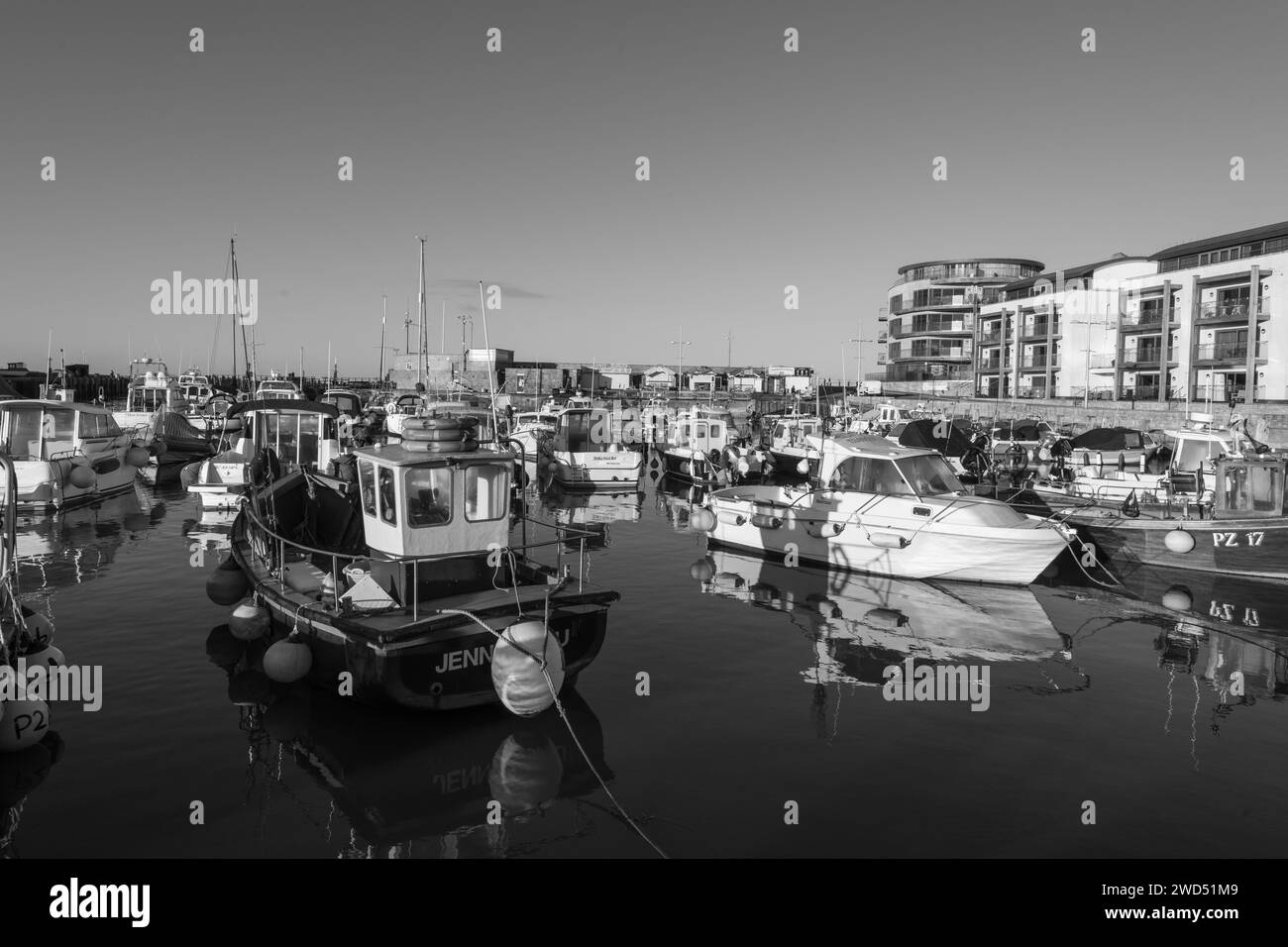 Fishing boats moored in West Bay harbour in Dorset Stock Photo - Alamy