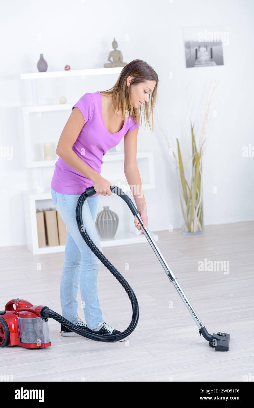 young woman vacuuming the home Stock Photo - Alamy