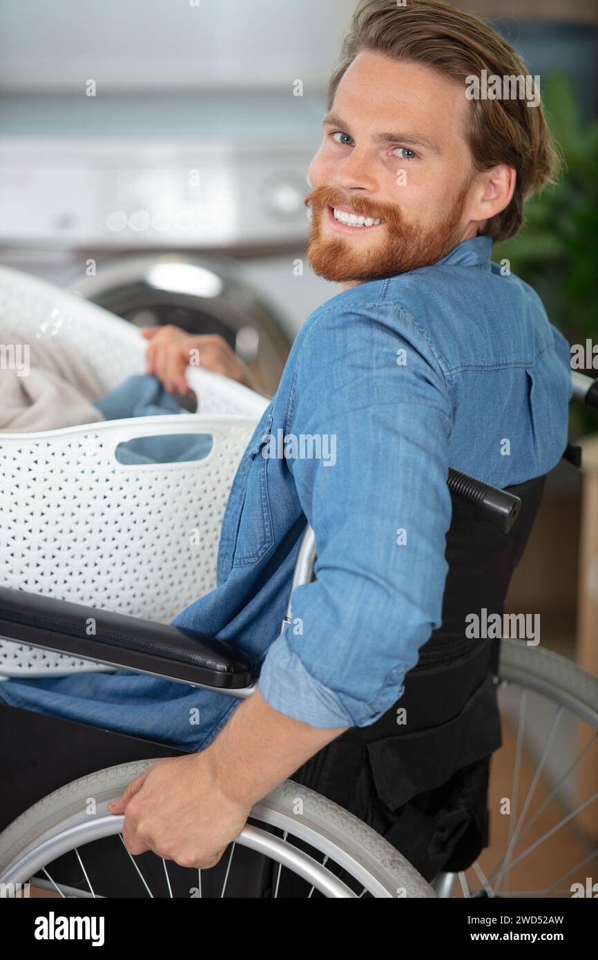 capable disabled man doing laundry Stock Photo
