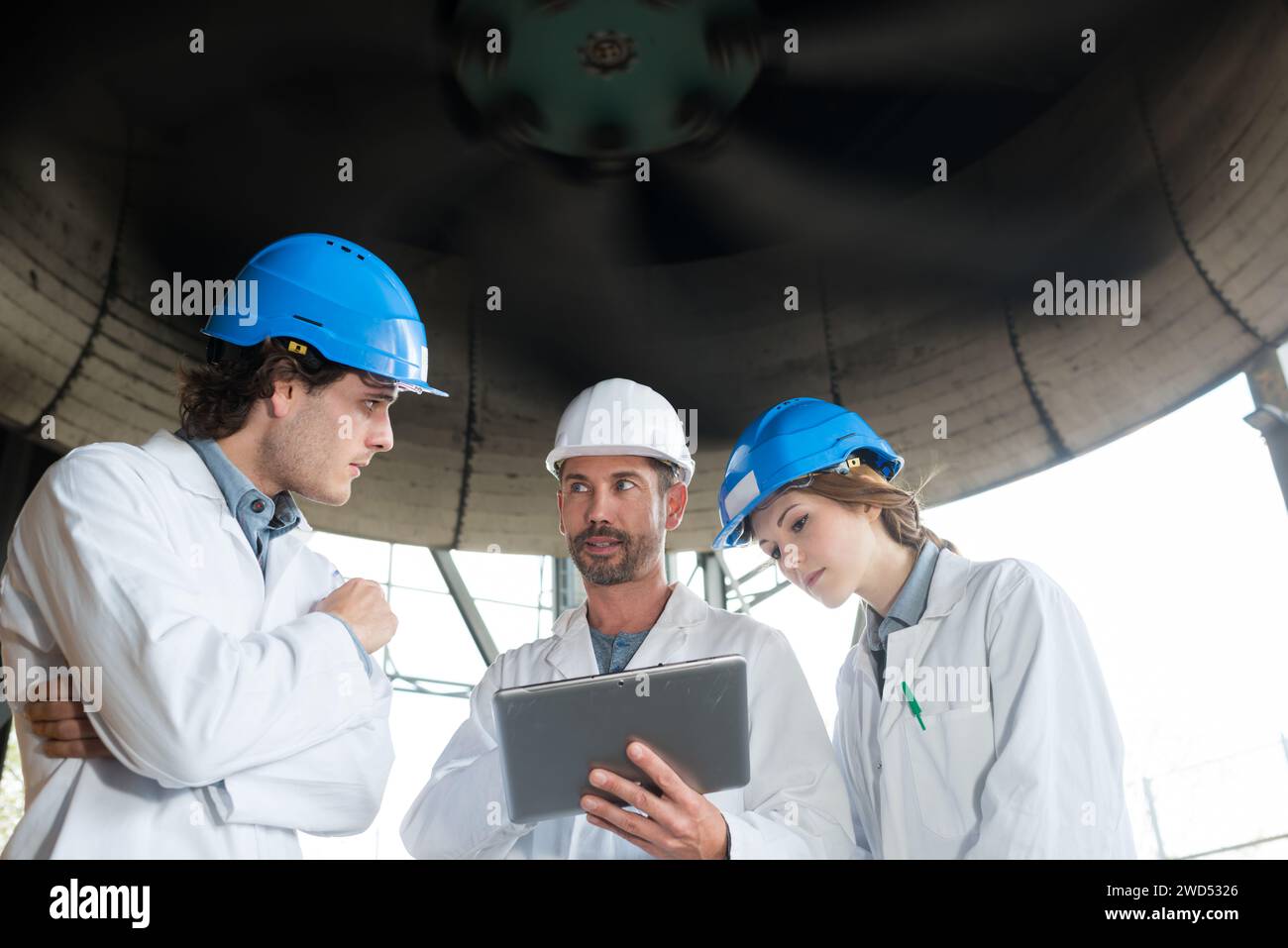 engineers checking installation in big industrial hall Stock Photo