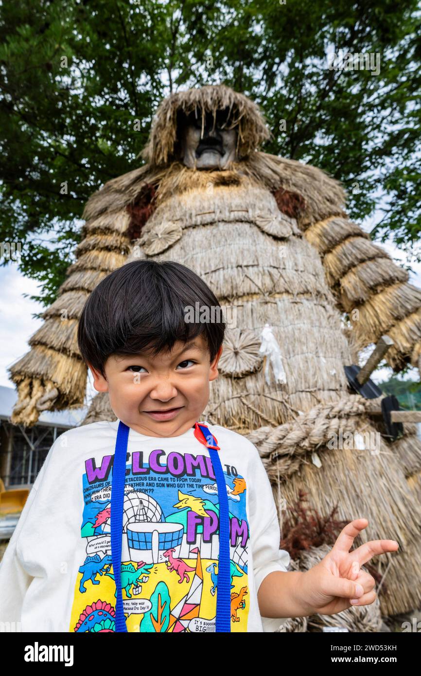 Boy imitating Giant straw doll, local guardian deity, named Kashima(Kashimasama), Iwasaki, Yuzawa city, Akita, Japan, East Asia, Asia Stock Photo