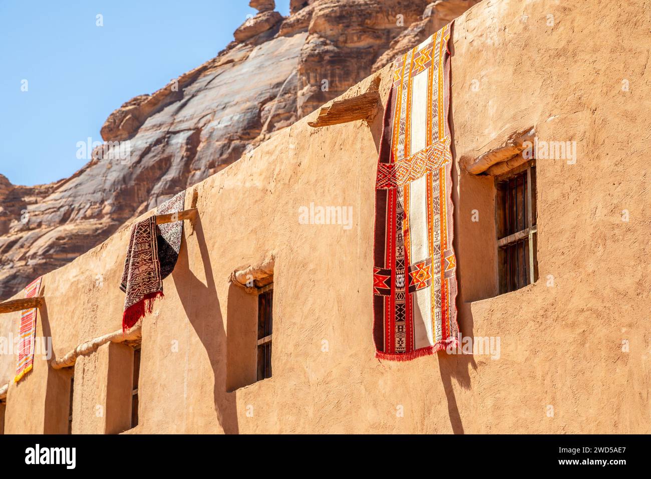 Ornated arabic carpets hanging from the roof of traditional mud houses, Al Ula, Medina province, Saudi Arabia Stock Photo