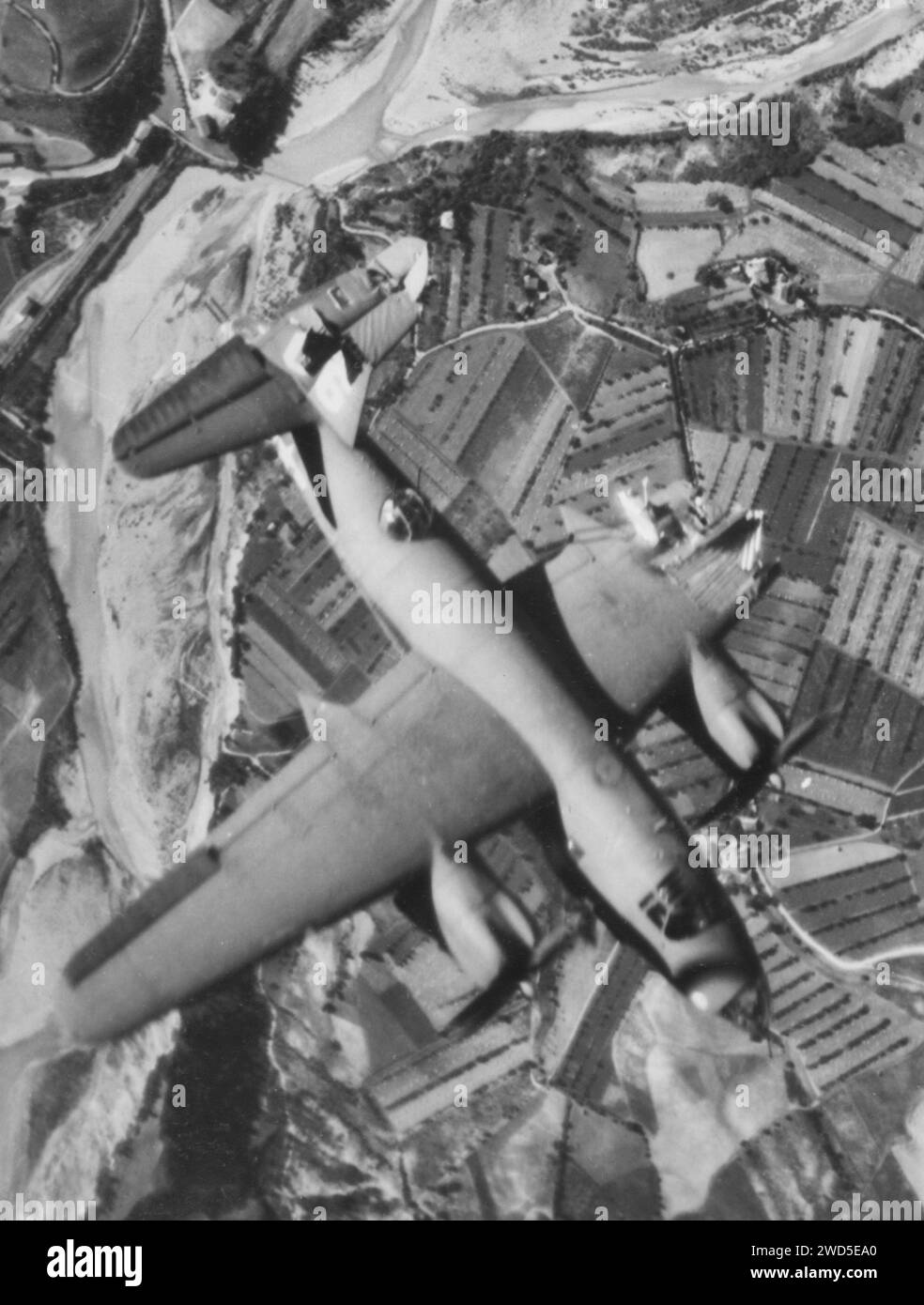 A B-26 Marauder of the 1st Tactical Air Force goes down over German-held Italy, with a missing left wing, (shot off by a Hun 88 mm flak shell), a rudder torn off and a broken plexi-glass nose. Stock Photo