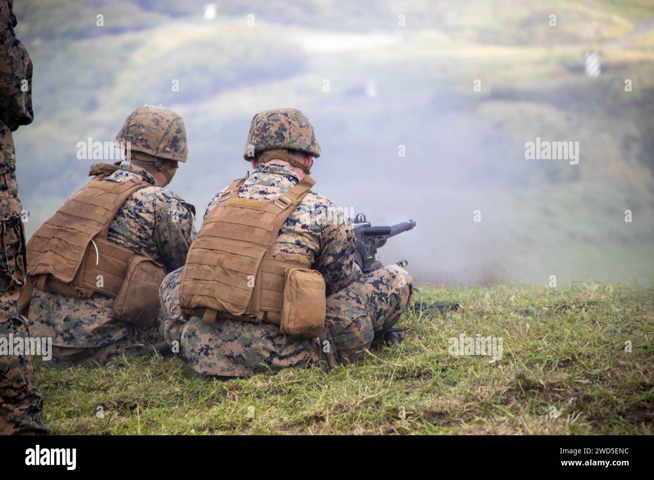 U.S. Marines with Marine Wing Support Squadron (MWSS) 174, Marine Aircraft Group 24, 1st Marine Aircraft Wing, fire M240-B and M2 .50-caliber machine guns at the Marine Corps Air Station Kaneohe Bay range, Hawaii, Jan. 16, 2024. The training provided an opportunity for Marines with MWSS-174 to get hands-on training and familiarization with the employment of crew-served weapons. (U.S. Marine Corps photo by Lance Cpl. Logan Beeney) Stock Photo