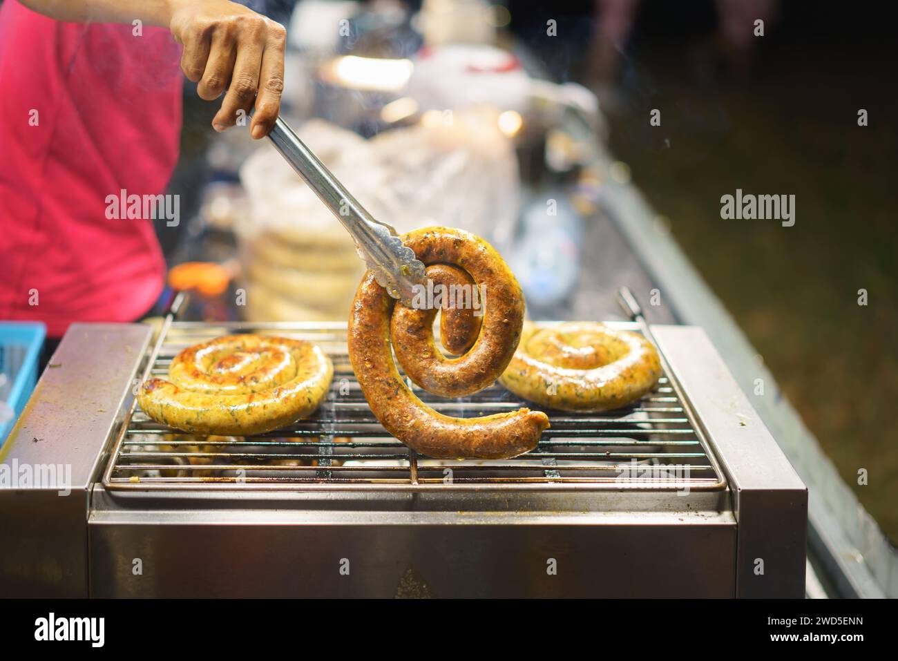 Northern Thai sausages sizzling on a grill aroma and vibrant flavors encapsulate the essence of northern Thai cuisine. Stock Photo