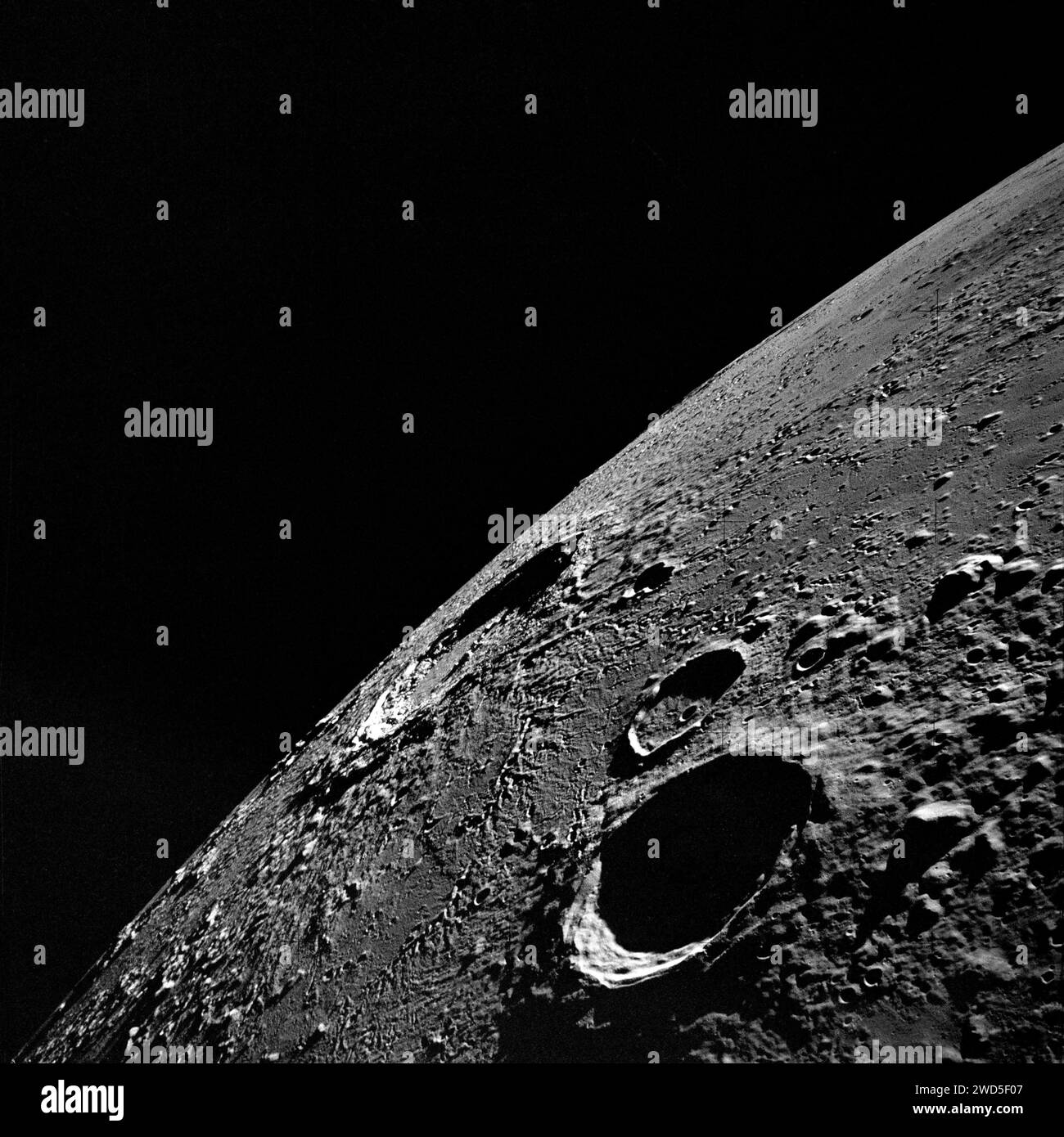 High-angle view of lunar nearside looking northeast toward crater Copernicus (in center near horizon), crater Reinhold (foreground) and the smaller crater Reinhold B (above Reinhold), as photographed from Apollo 12 spacecraft, NASA, November 19, 1969 Stock Photo