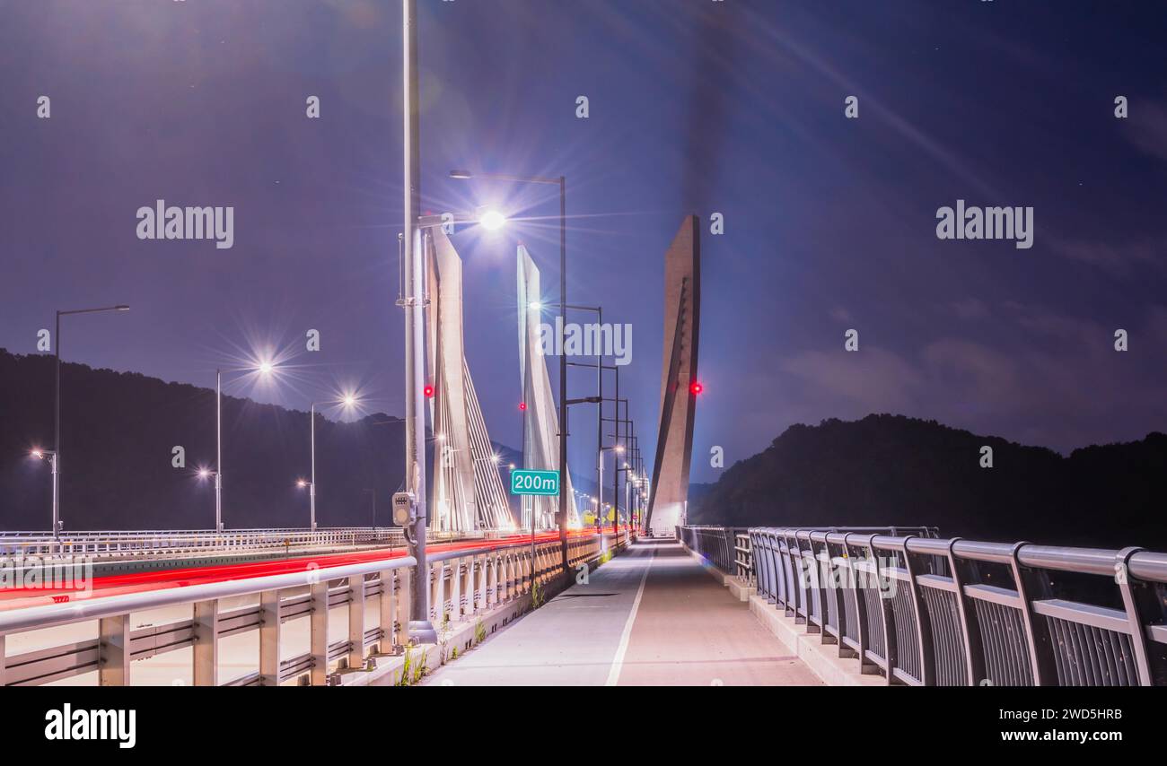 Long exposure night view of Aramchangyo bridge designed by SK E&C near Sejong city in South Korea with red light streaks from passing cars. Contains Stock Photo