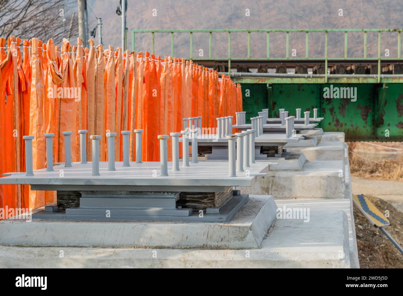 Closeup of steel base plates for concrete columns on bridge under