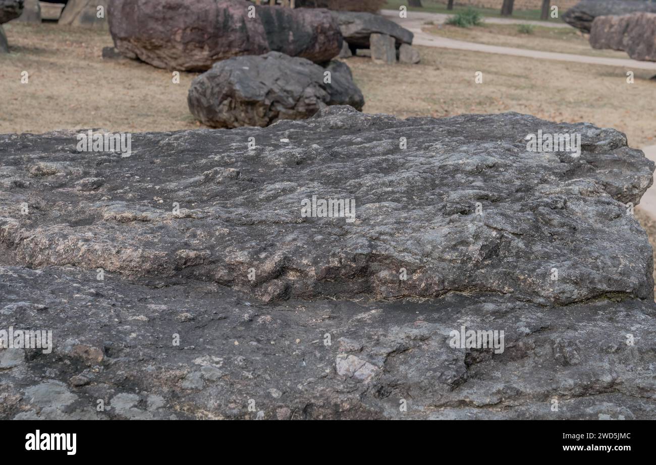 Closeup of large boulder used as capstone on dolmen tomb with similar