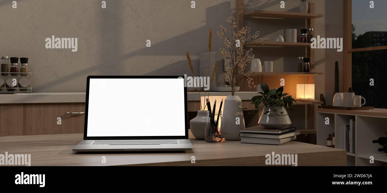 A white-screen laptop computer on a kitchen island in a modern kitchen at night. home workspace concept. 3d render, 3d illustration Stock Photo