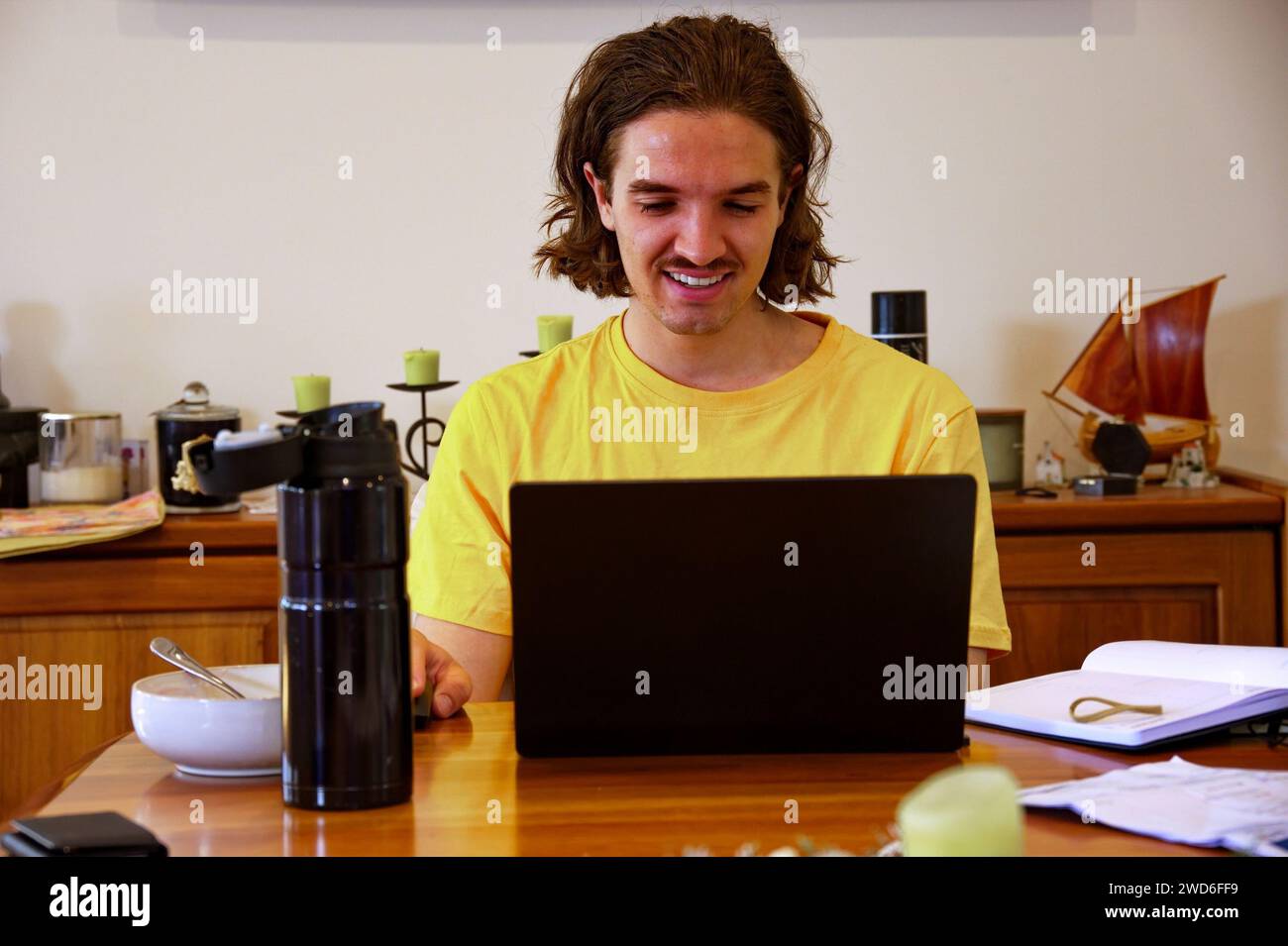 Young man working on laptop from home Stock Photo