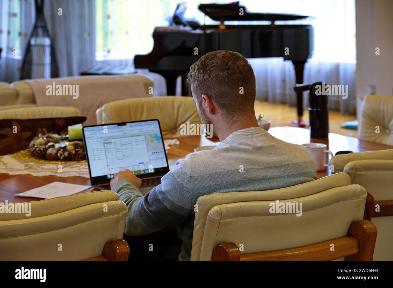 Young man working on laptop from home Stock Photo