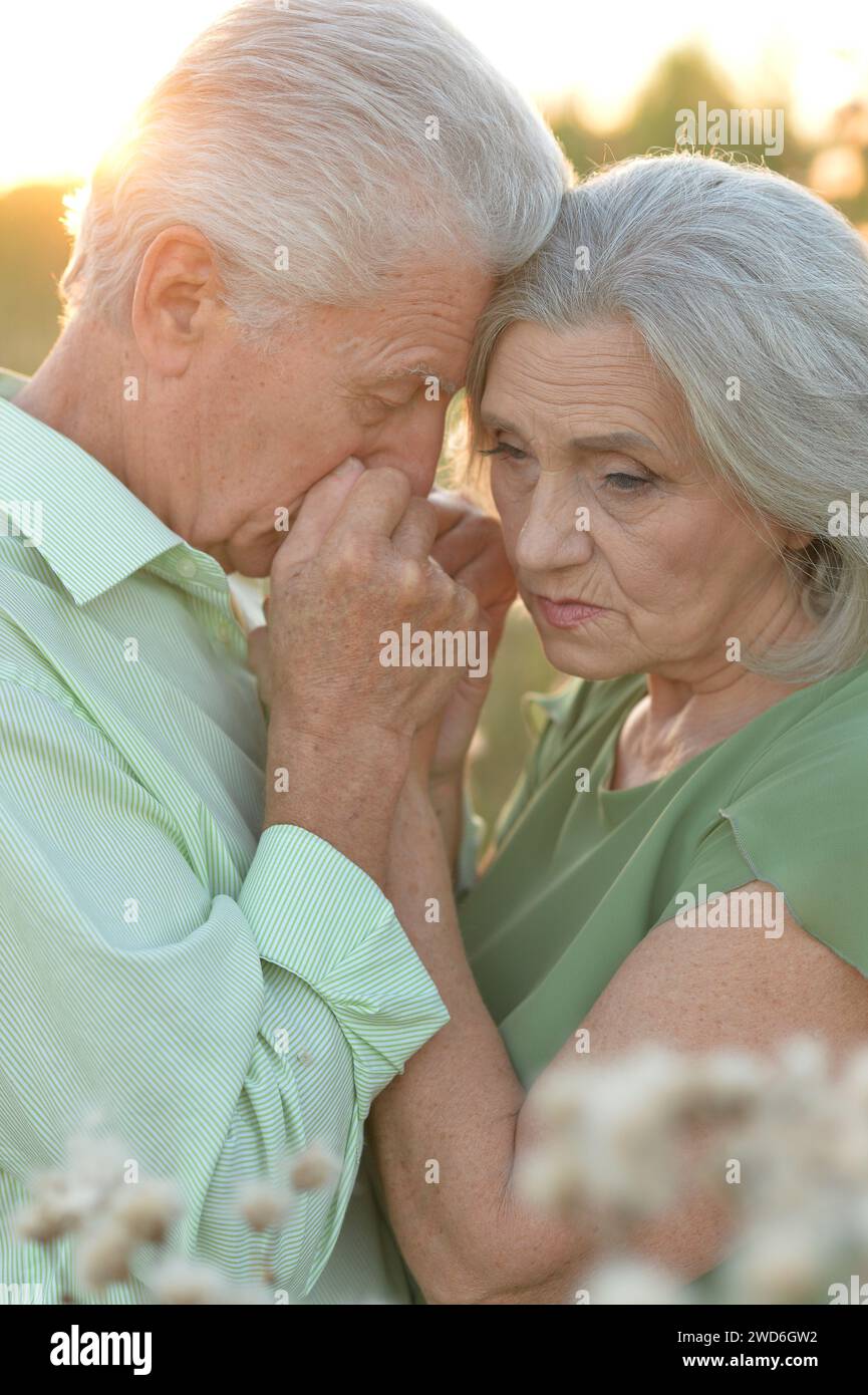 Portrait of sad elderly couple standing outdoors Stock Photo
