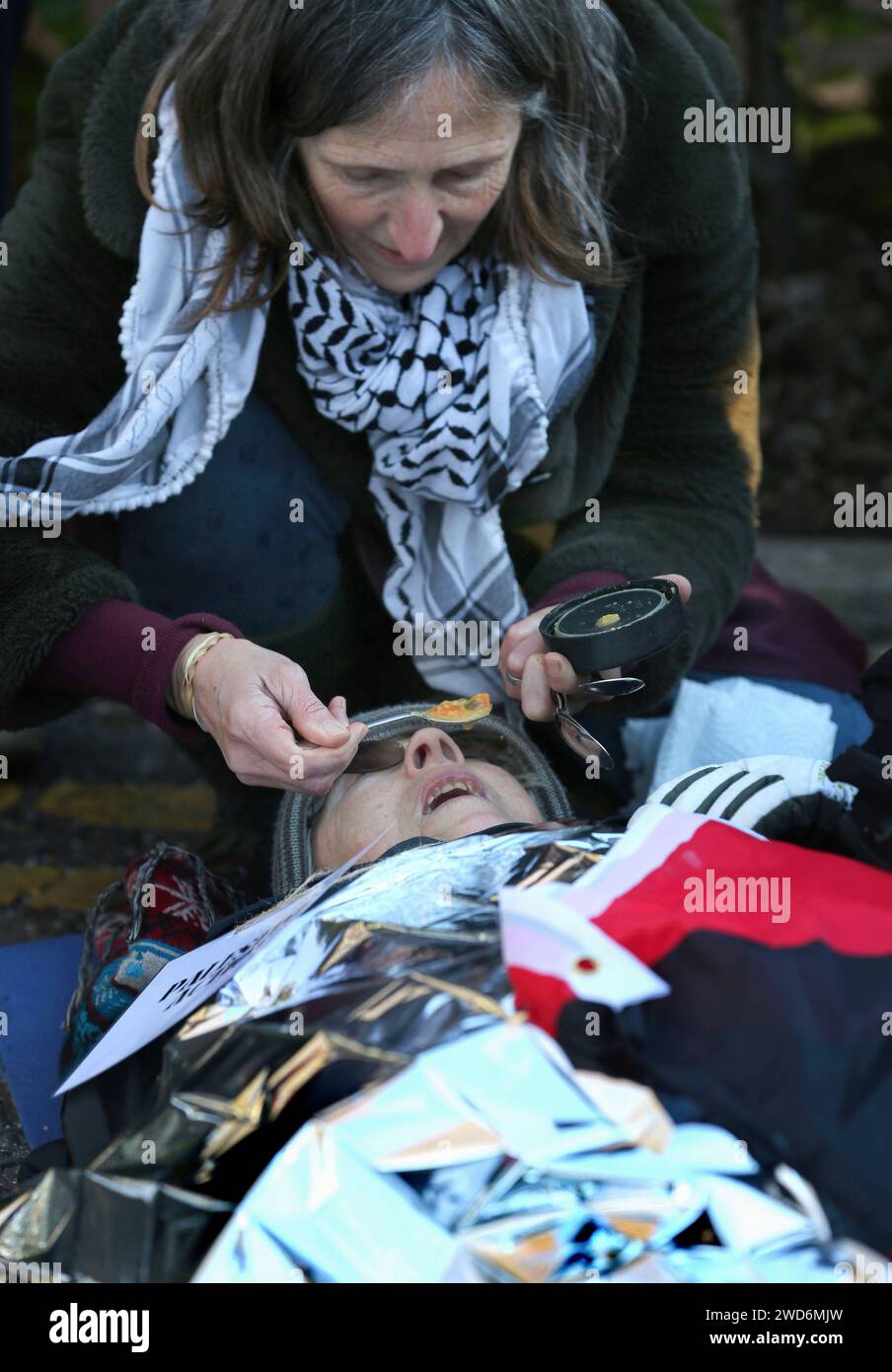 Bristol, UK. 18th Jan, 2024. A supporter feeds one of the activists ...