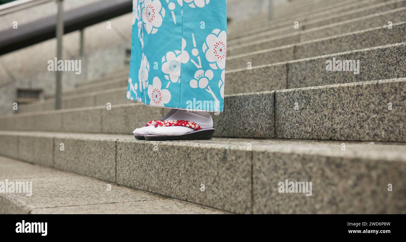 Feet, stairs and person in Japanese kimono for travel, tourism or Tokyo sightseeing closeup. Sandals, steps and culture with tourist outdoor in Stock Photo