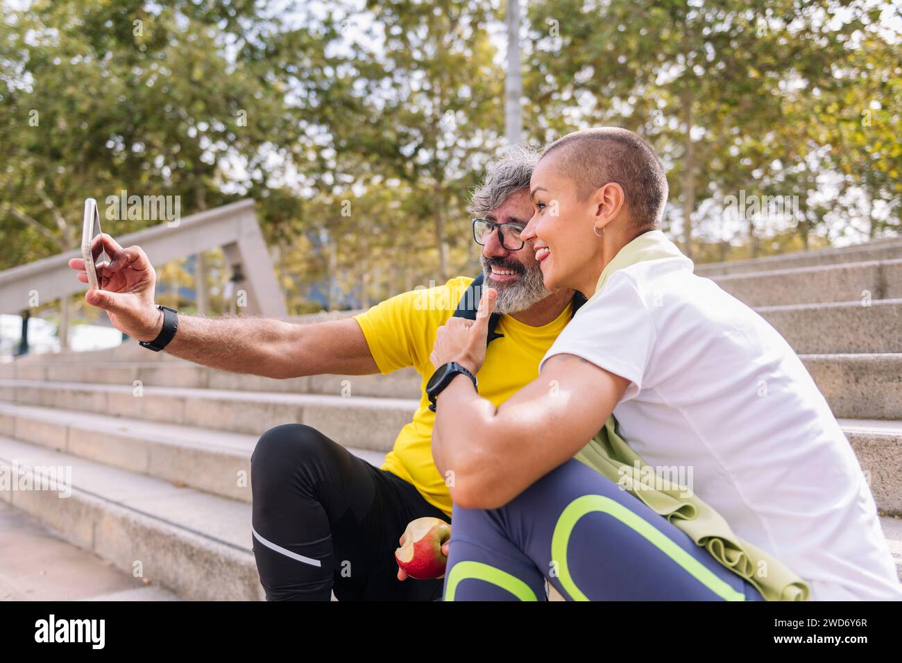 senior man taking a selfie with personal trainer Stock Photo
