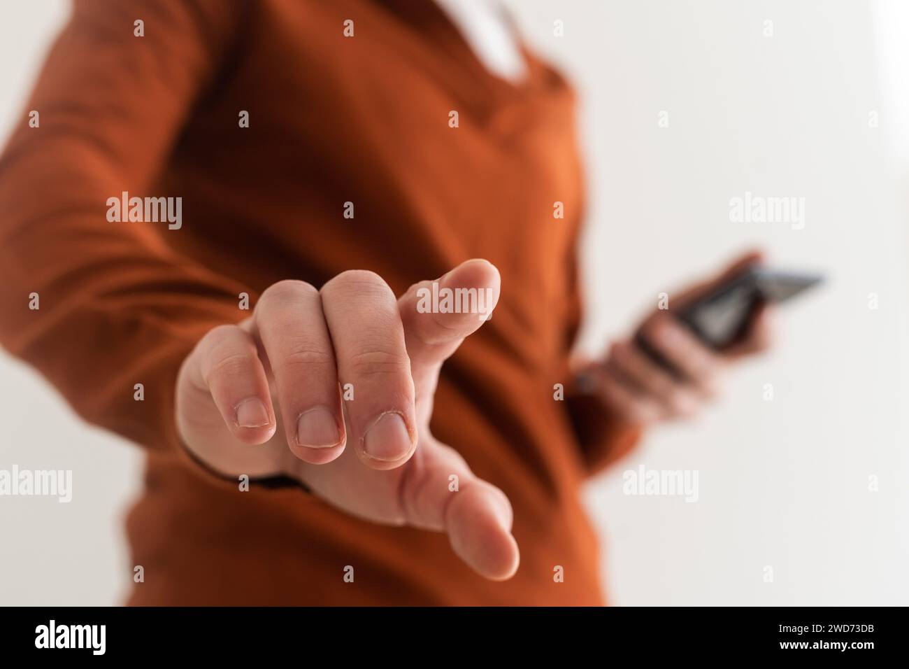 Businessman pressing an imaginary button on bokeh. Stock Photo