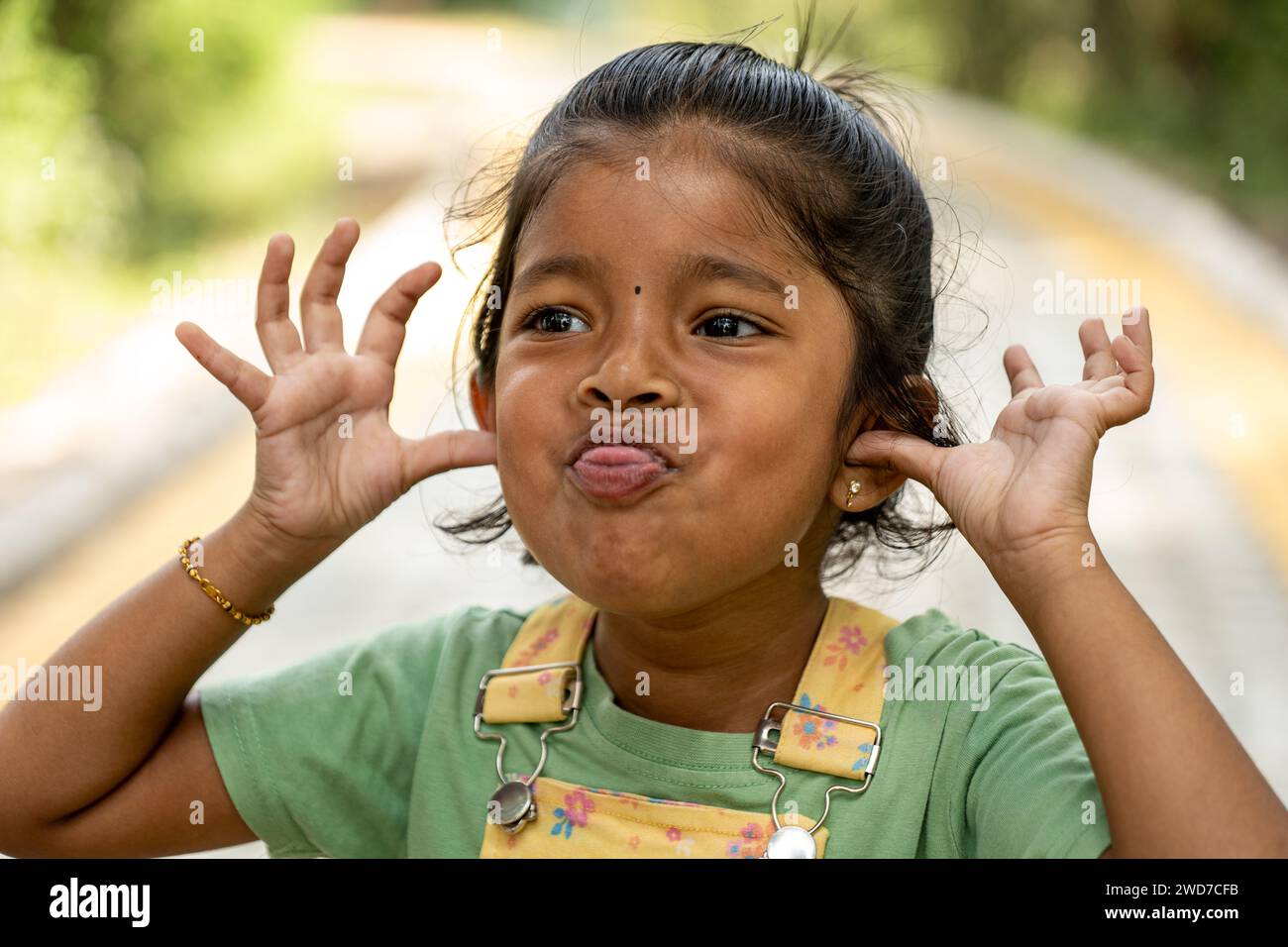 This heartwarming image captures the pure joy of childhood through a kid's unrestrained silly faces Stock Photo