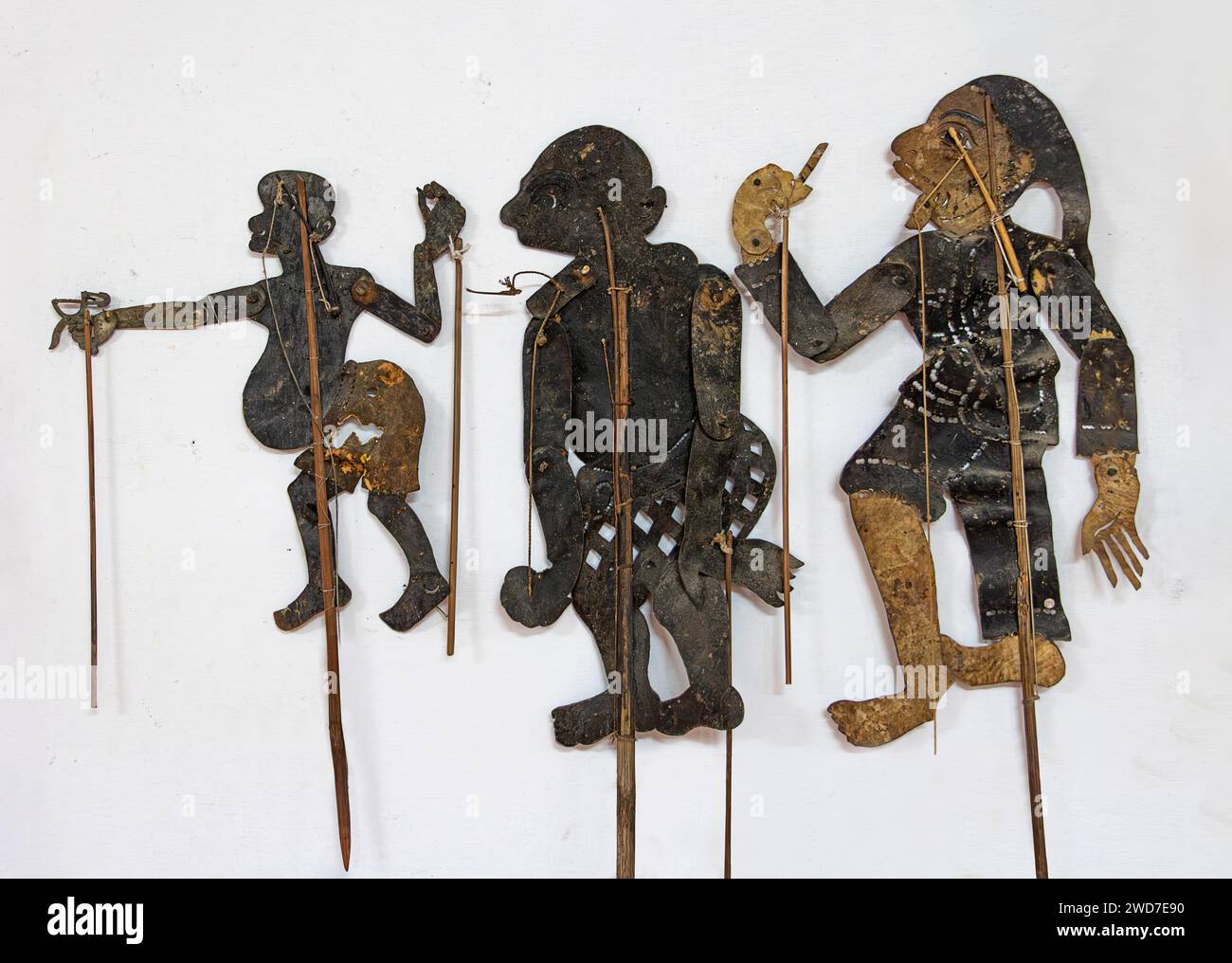 The puppet figurines for shadow theater is hanging on a white wall, Thailand Stock Photo