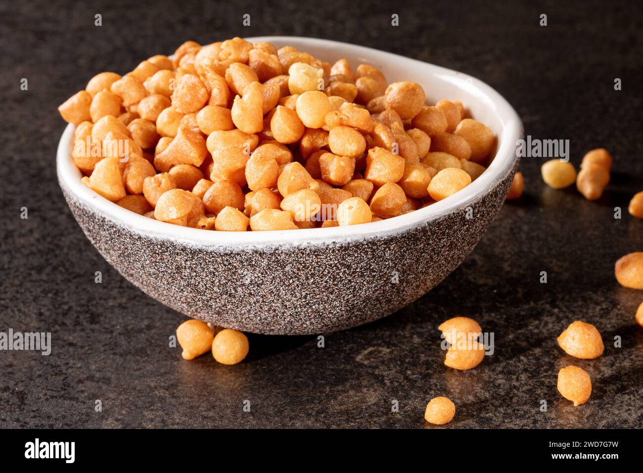 Delicious soup filling a bowl with snack product on dark background Stock Photo