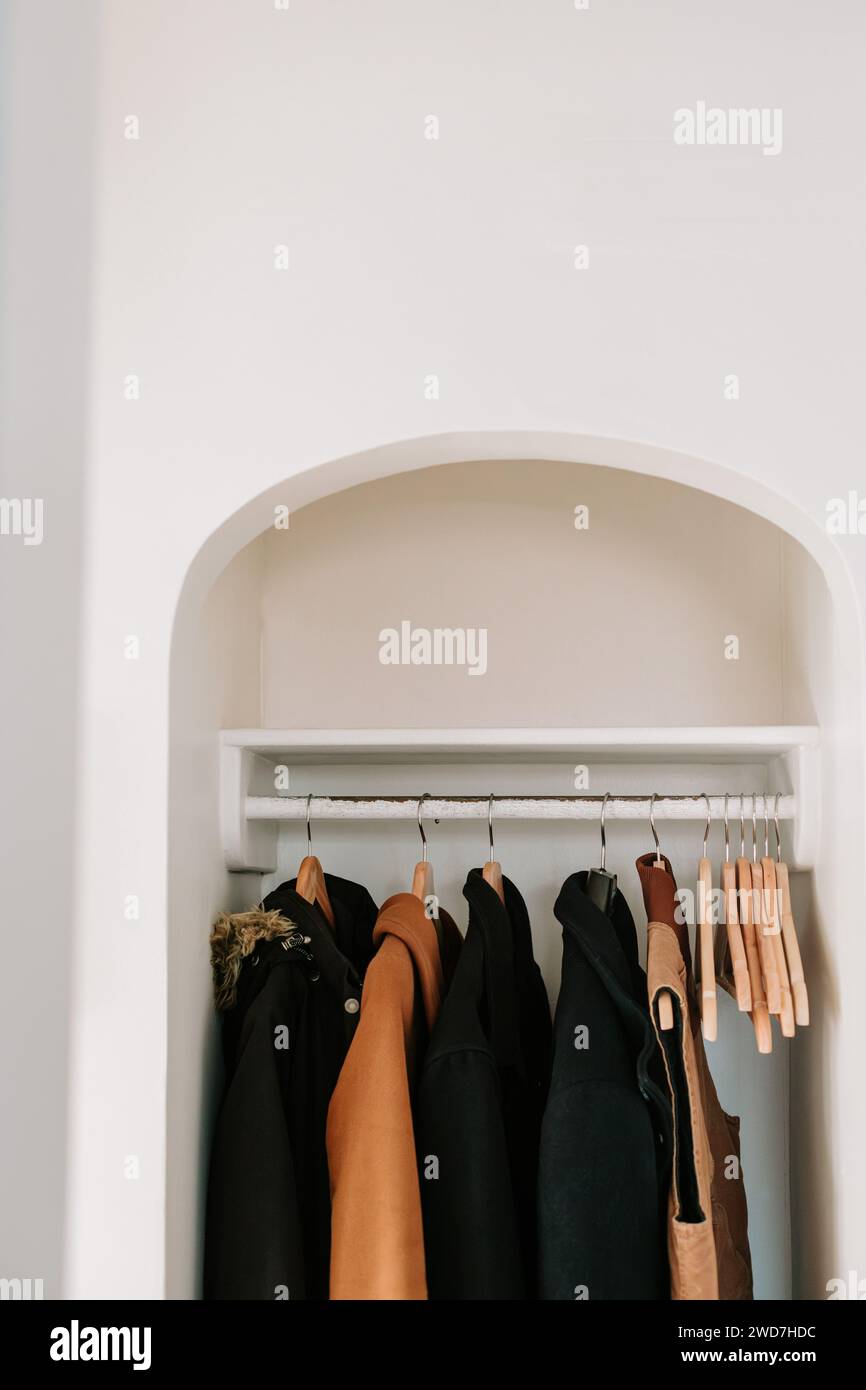 Coats hanging home hi-res stock photography and images - Alamy