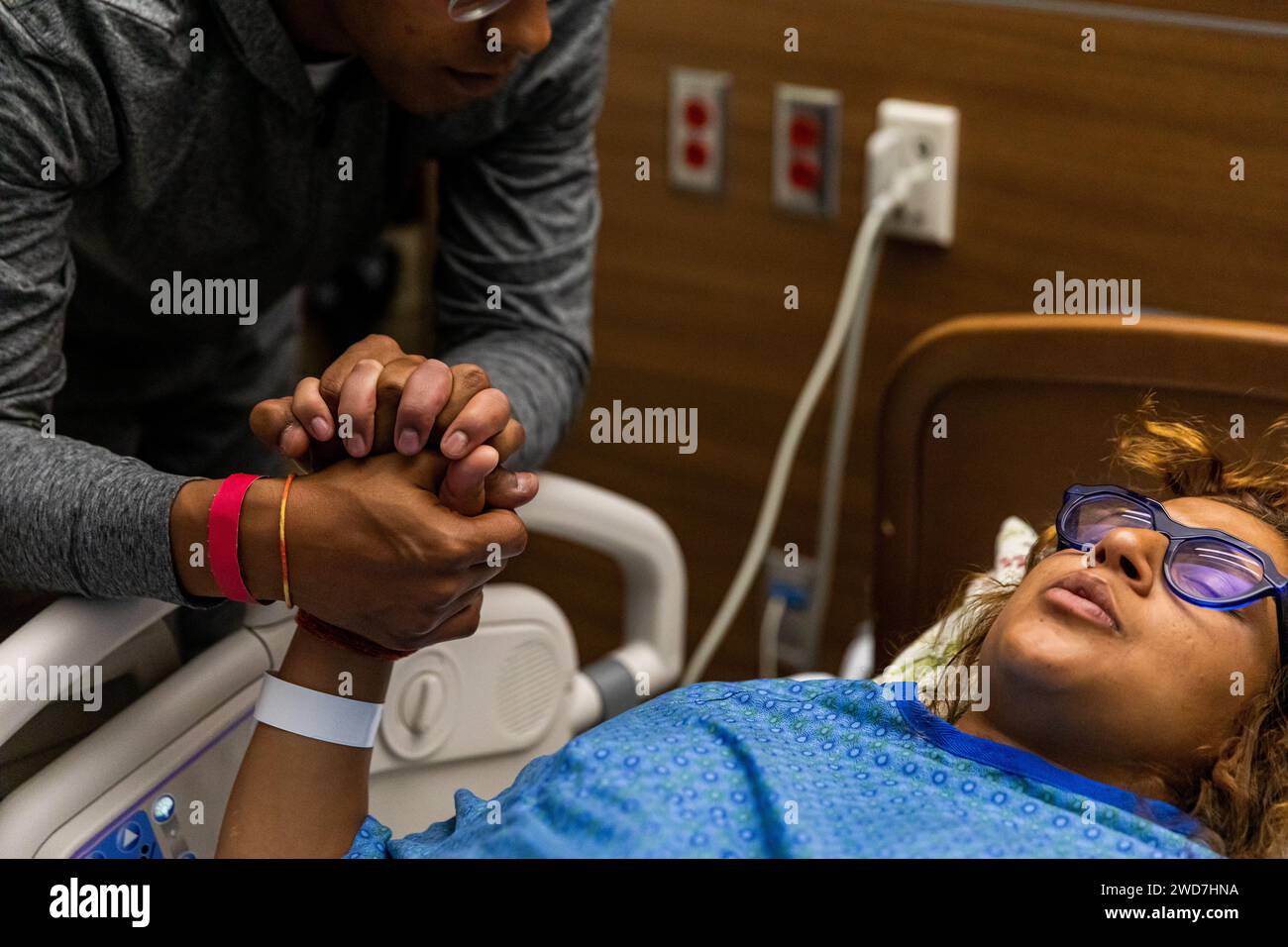 Multiracial couple breathes through contraction while holding hands Stock Photo