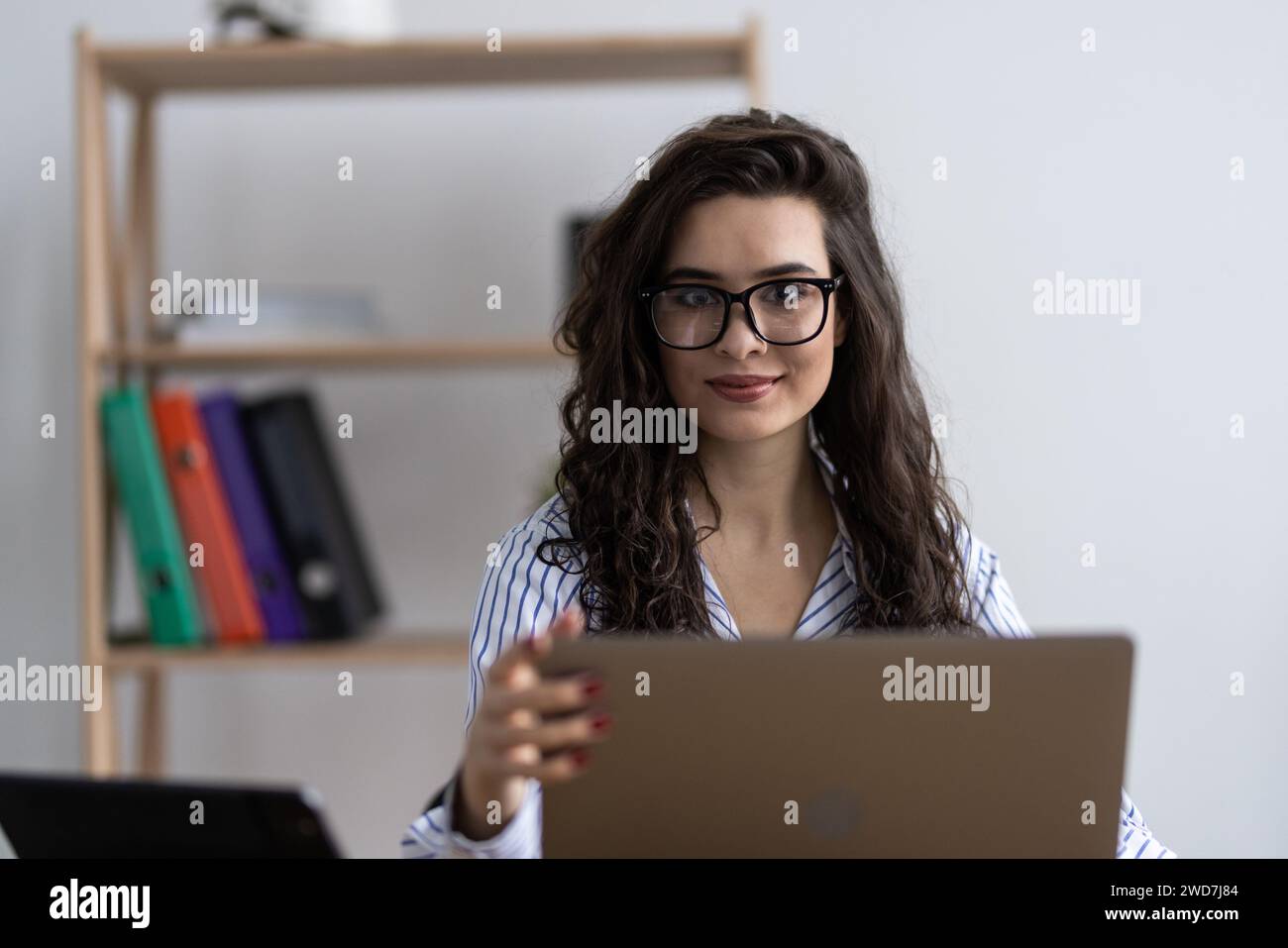 Shot of an attractive businesswoman working on laptop in her workstation. Stock Photo