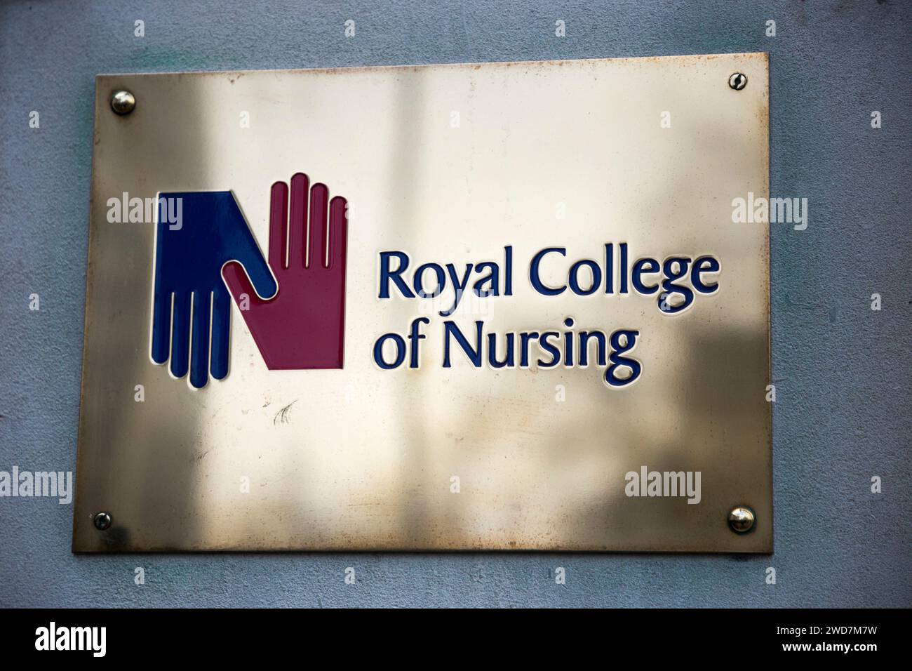 Brass name plate / plaque outside the offices of / on office
