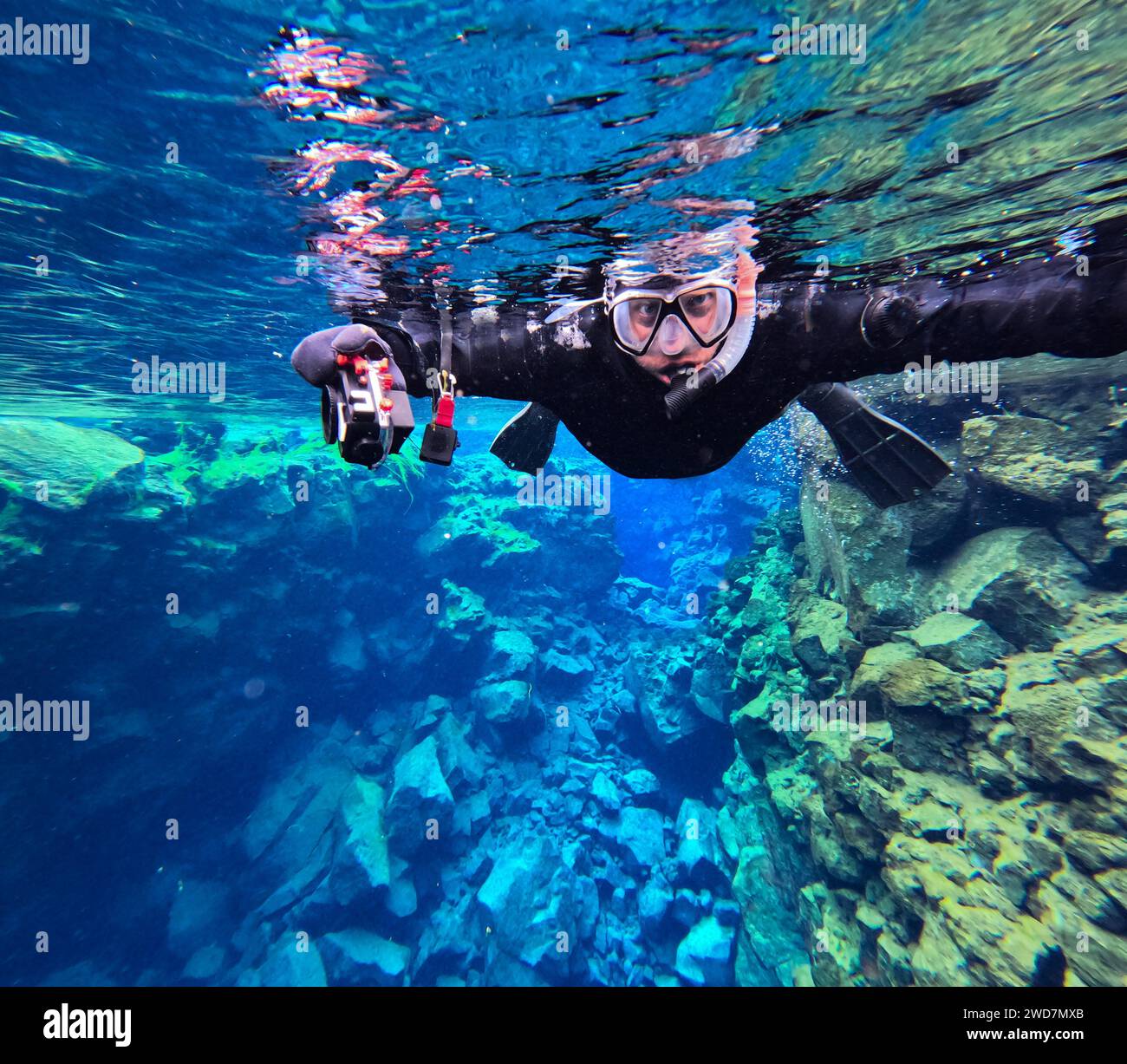 Man snorkels through glacial water underwater canyon Stock Photo Alamy