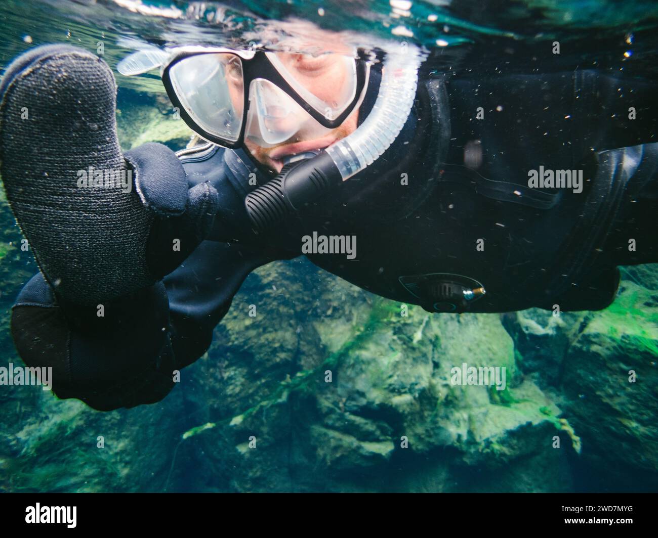 Man with snorkel mask underwater gives okay sign Stock Photo