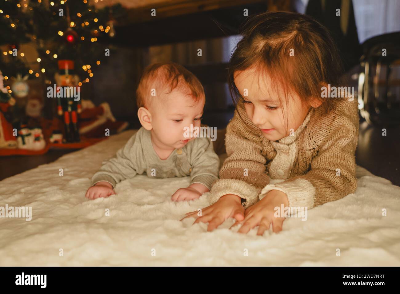 little girl and baby near the christmas tree, christmas celebrate Stock Photo