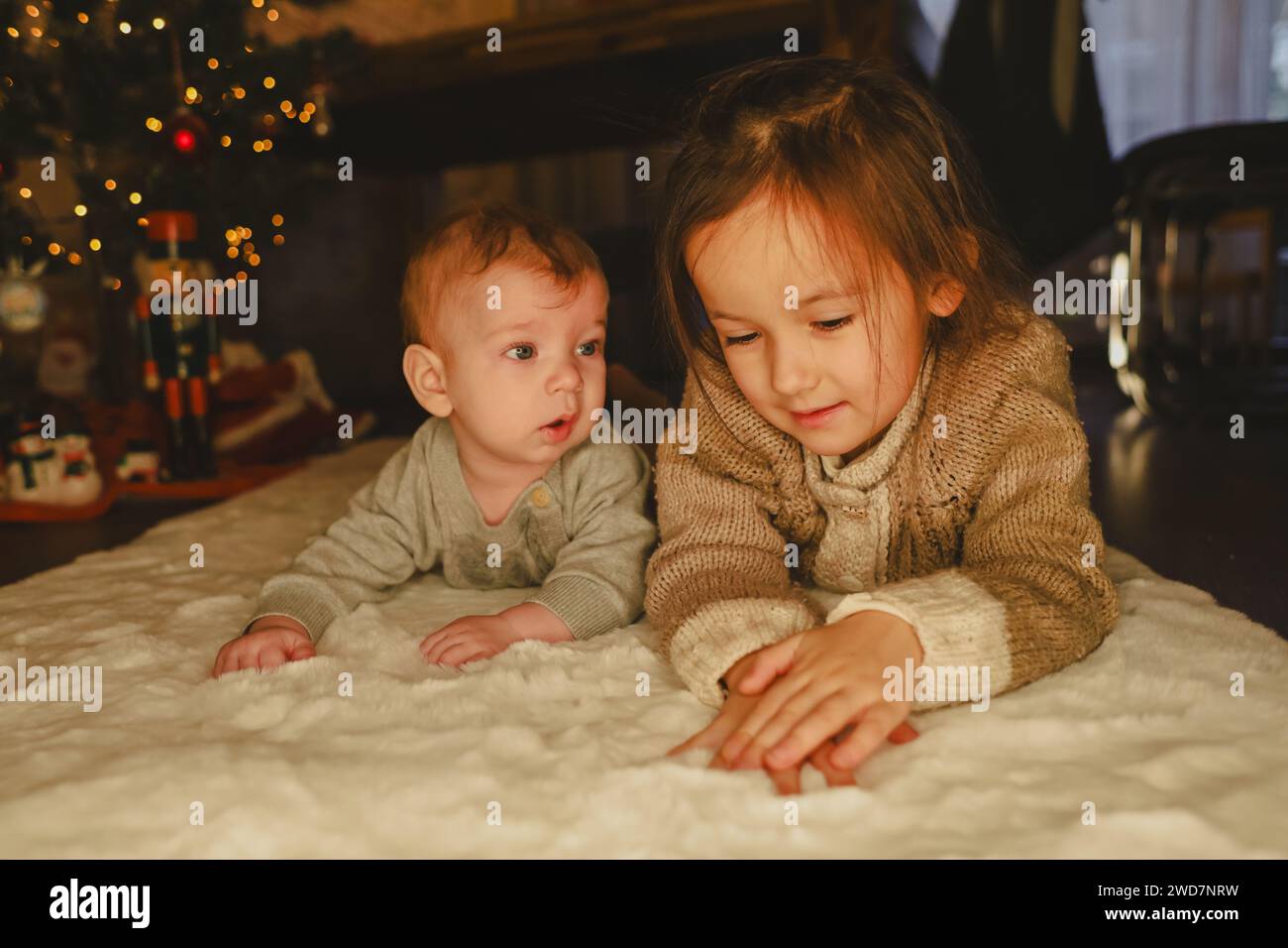 little girl and baby near the christmas tree, christmas celebrate Stock Photo